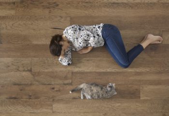Best Engineered Wood Flooring Brands Featured Image of Woman and Cat on Wood Floor