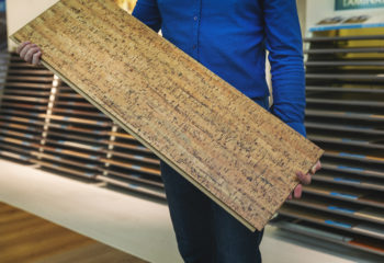 Best Cork Flooring FI—Man holding cork plank