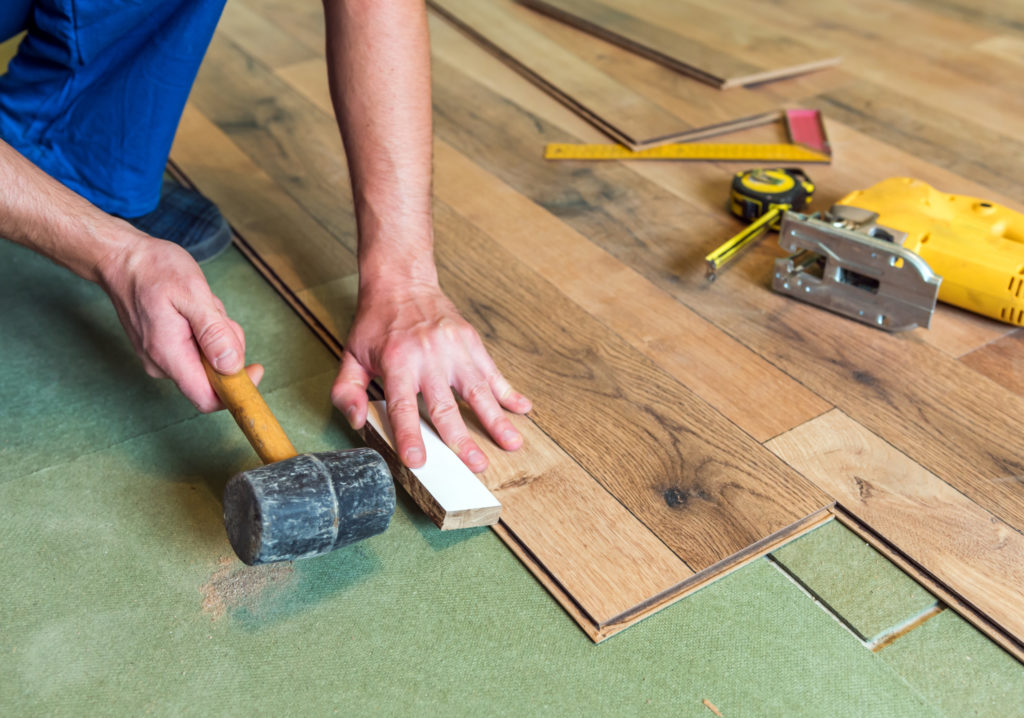 Hammering in LVT vinyl floor with mallet click-together flooring