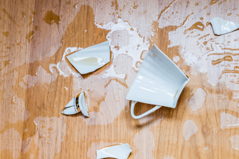 water-resistant wood flooring featured image of a broken coffee mug on a wood floor
