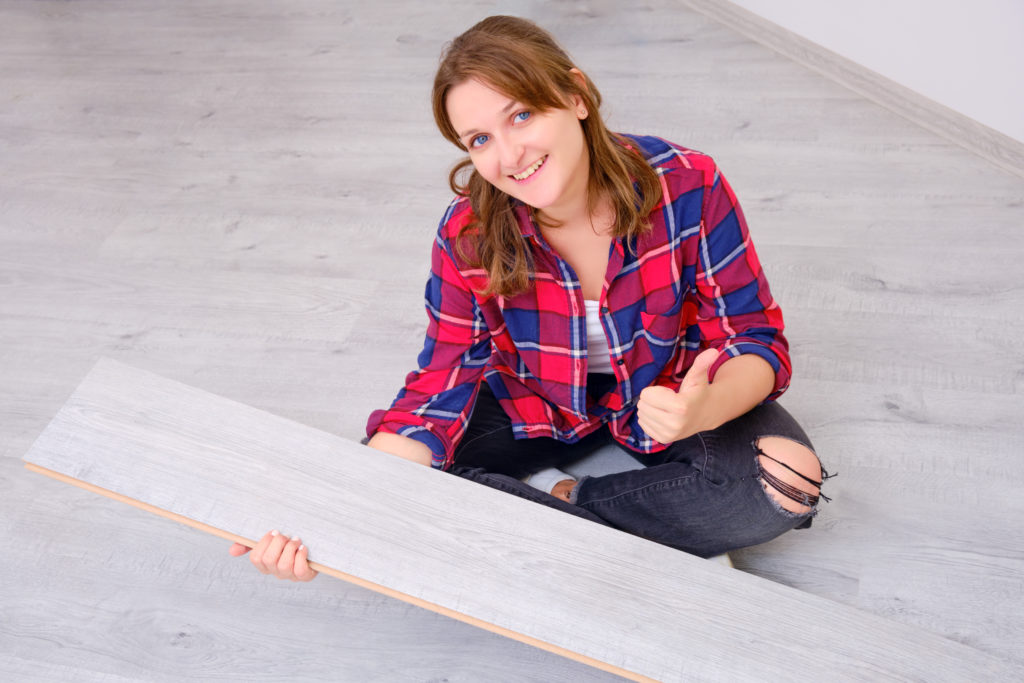 Woman installing floor