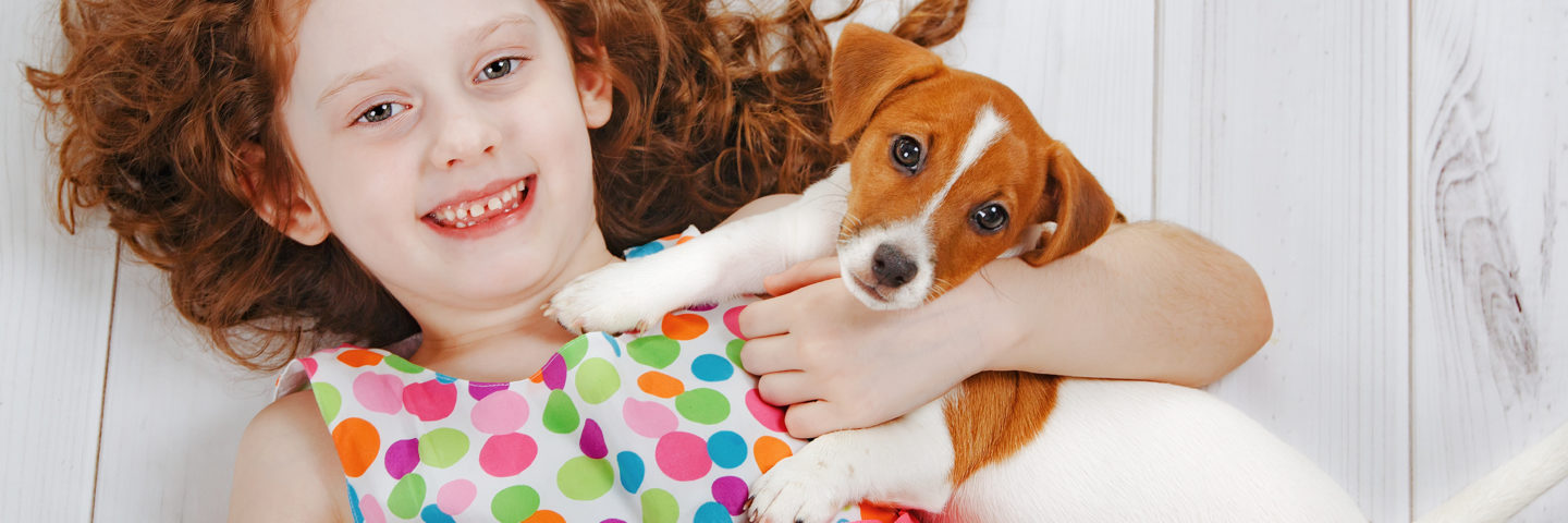 Sustainable Wood Flooring Featured Image of Redhead Child on White Wood Floor with Small Terrier Dog