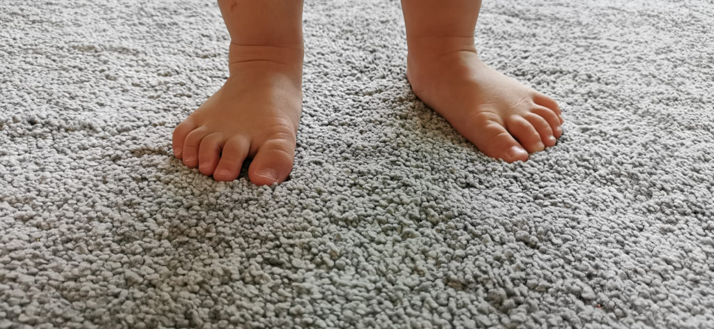 Child's feet on fiber surface