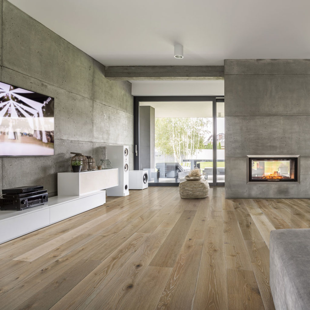 brown wide plank hardwood flooring in a modern living room with fireplace