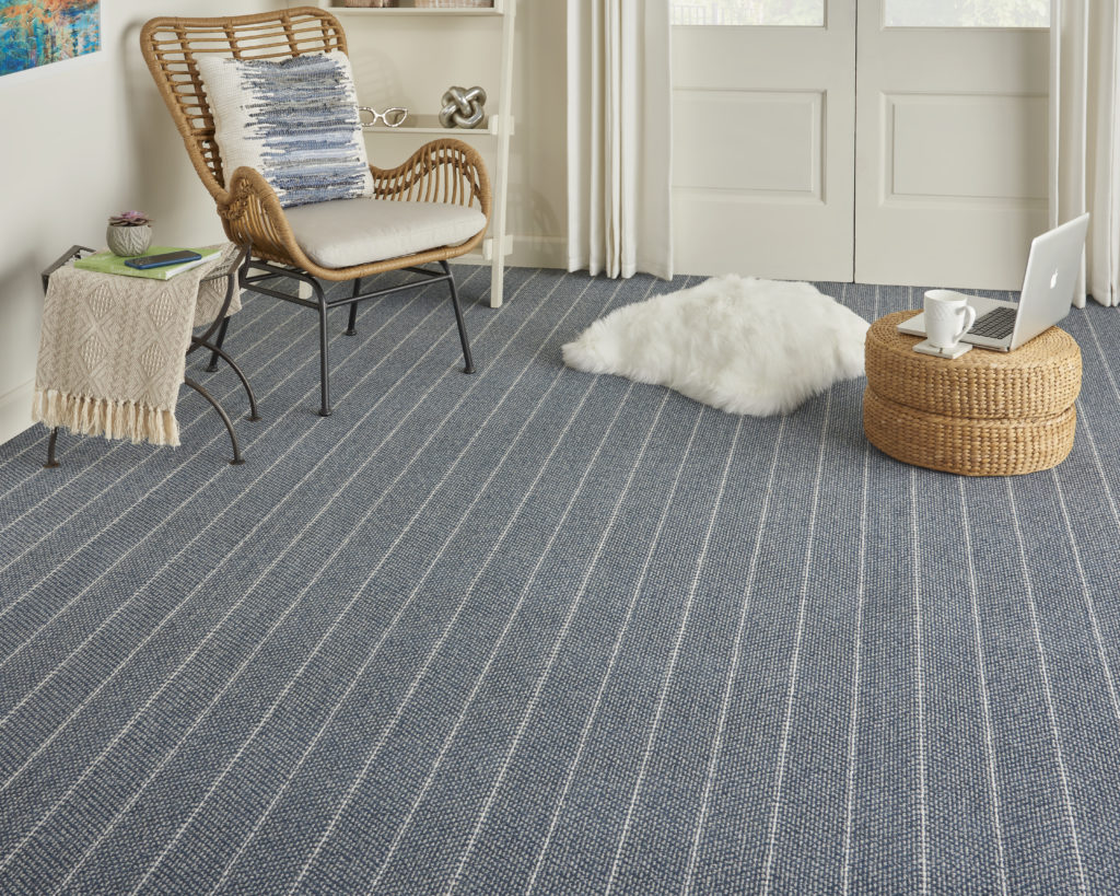 Doma carpet, striped, in a family room scene. Doma is one of the best carpet brands thanks to its bold styles.