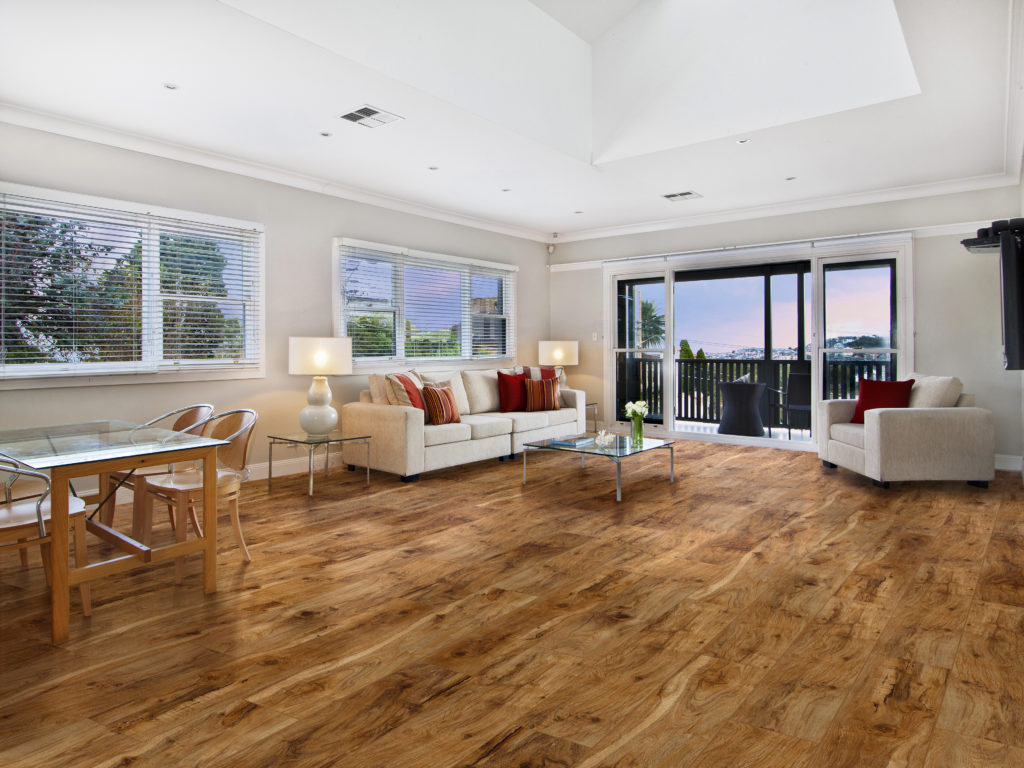 wood-look vinyl flooring in a living room with a white couch