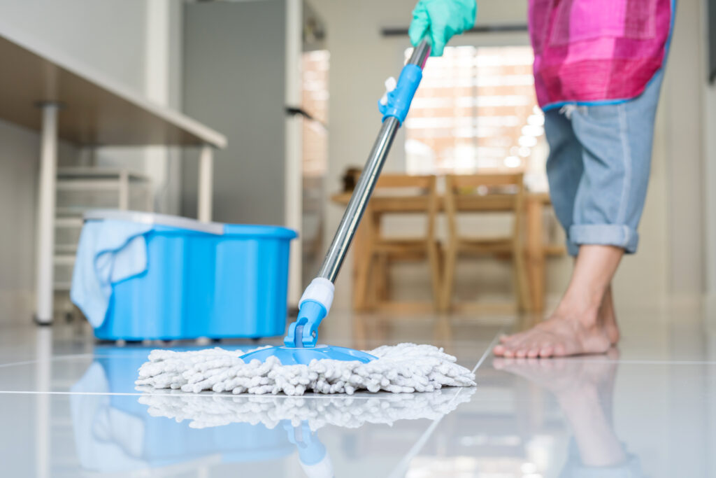 Homeowner cleaning and maintaining their tile flooring